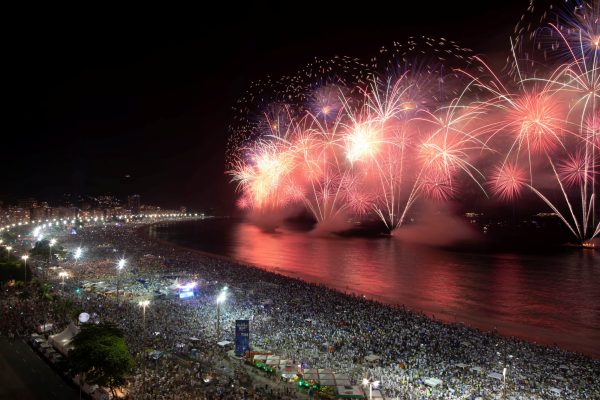 People watch as fireworks explode over Copacabana beach during New Year celebrations in Rio de Janeiro, Brazil January 1, 2020. REUTERS/Ueslei Marcelino