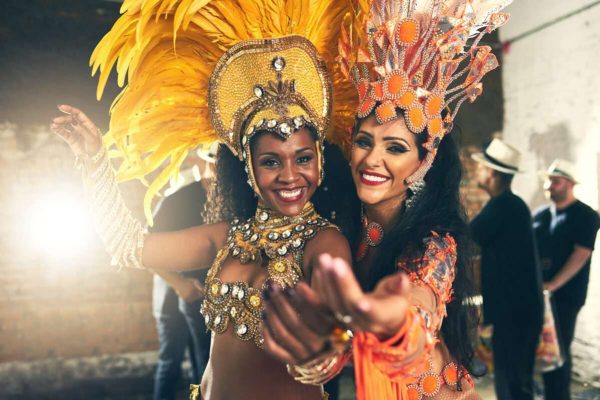 we-live-perform-cropped-portrait-two-beautiful-samba-dancers-performing-carnival-with-their-band-1199x800